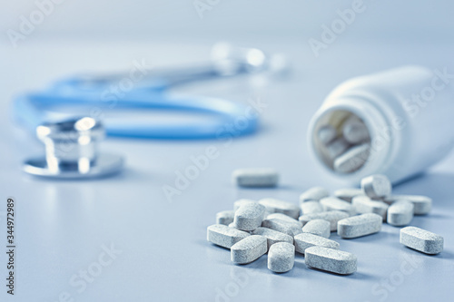 Close-up of a medical stethoscope and many pills