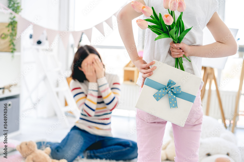 Daughter giving pleasant surprise for mother's day Daughter giving pleasant surprise for mother's day