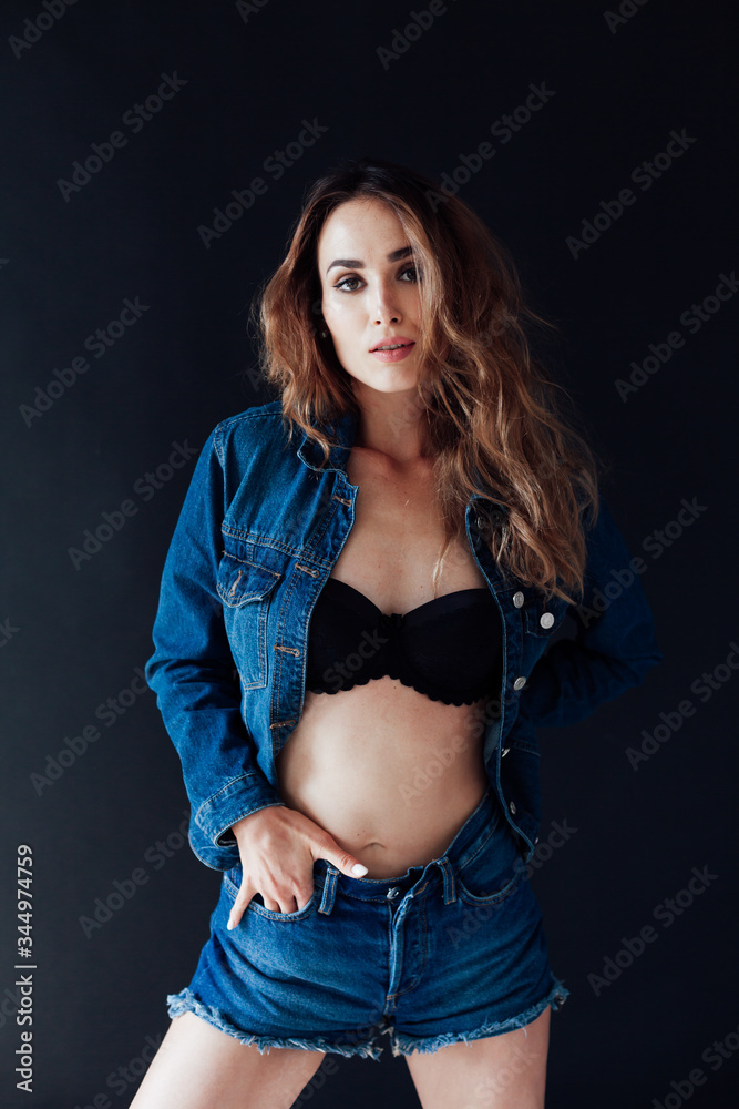 portrait of a beautiful fashionable woman in lingerie and denim shorts