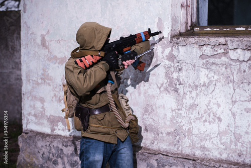 Rebel aiming with AK to window