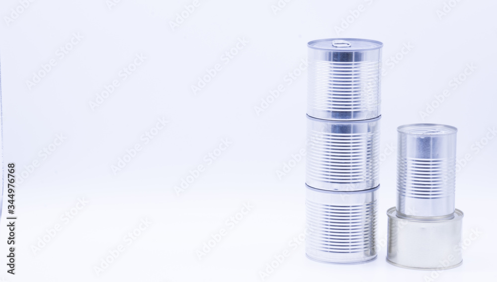 Donation with three cans of canned food on white, peas and corn, food stock for quarantine, isolation period on white. Donation, coronavirus Donation with three cans of canned food on white, peas and corn, food stock for quarantine, isolation period on white. Donation, coronavirus