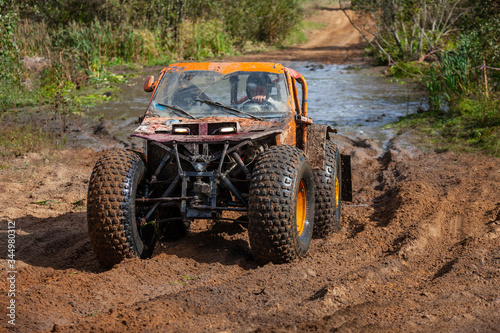 Lepel, Belarus, 19.09.2010. Open championship of jeep trial. Offroad race in the forest. Utility vehicle splashing dirty and muddy water around. Challenge between technical achivements and nature.