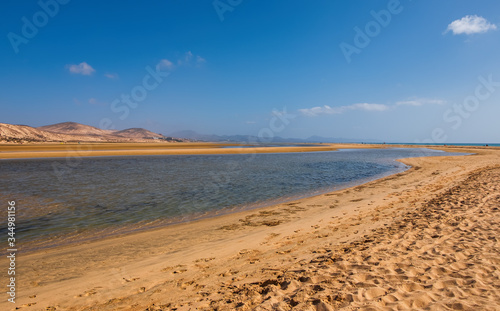 Playa de Sotavento, Fuerteventura, Spain-october, 2019: Sotavento beach, couple walks along the ocean