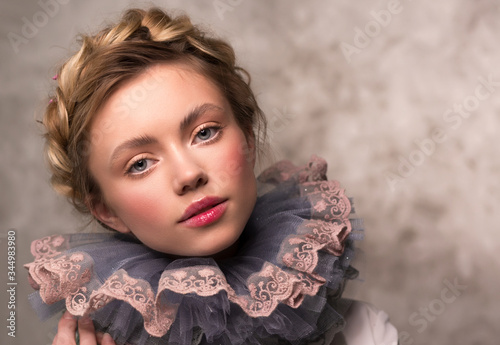 Portrait of a woman in a vintage medieval collar. Countess or princess. Lush ruff in the neck circle.