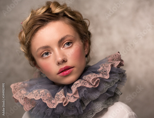 Portrait of a woman in a vintage medieval collar. Countess or princess. Lush ruff in the neck circle. photo