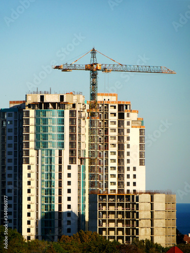 Wallpaper Mural Crane near building. Concrete building under construction. Torontodigital.ca