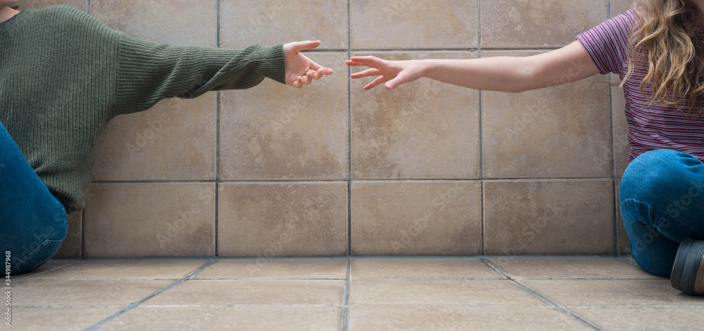 Distance Between Two Girls Social distance. Front view of two girls sitting on the floor. They're ...