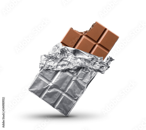 Tableau sur toile Bitten milk chocolate bar in foil. Isolated on white background