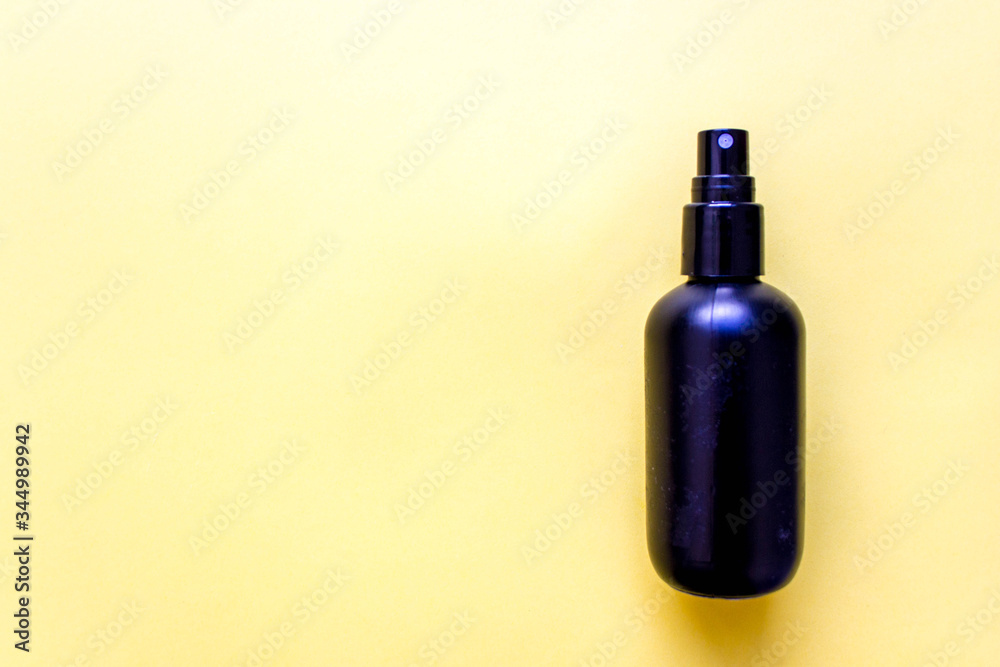 black plastic containers made from recycled plastic and reused for cosmetics on yellow background. Concept of recycling and eco-friendly use. Free copy space. Top view black plastic containers made from recycled plastic and reused for cosmetics on yellow background. Concept of recycling and eco-friendly use. Free copy space. Top view
