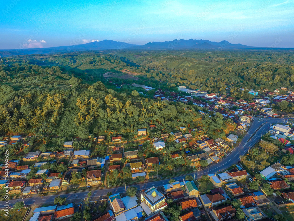 Aerial village in Sumbawa Indonesia, there are small city and beautiful green field in the morning view. Aerial City of Sumbawa