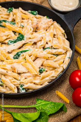 Chicken Alfredo Pasta with Spinach. Selective focus.