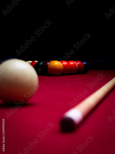 Billiard balls on a red felt pool table