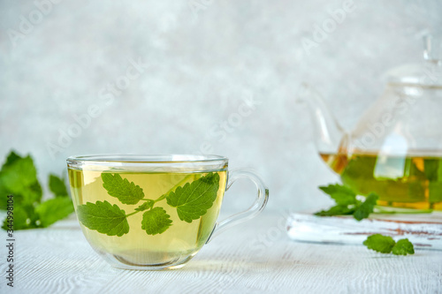 Fresh natural melissa , lemon balm herbal tea in glass cup. 