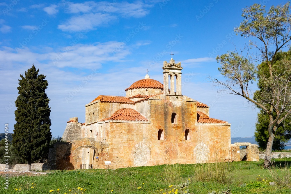 Metamorphosis Sotiros church in Pylos Nestor Palace (Niokastro Navarino) and trees in Greece at sunny day