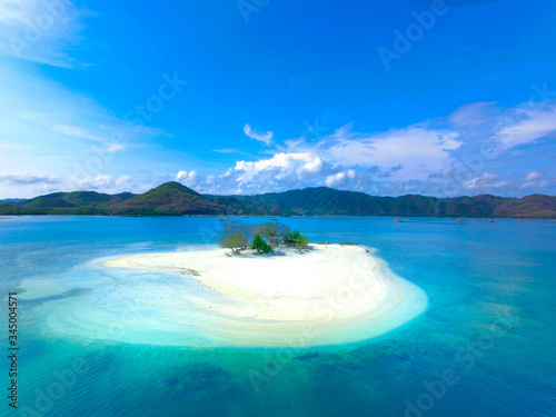 Aerial Isolated island with clear water and blue sky. Gili Kedis Lombok