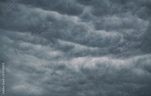 The texture of dark storm clouds; bottom view of stormy fractal supercells on the sky