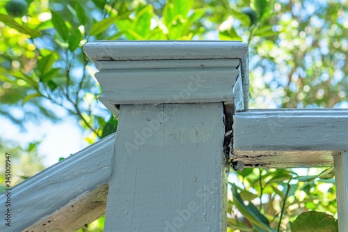 Rotting and separating wooden handrail where it meets the newel on this outdoor residential staircase