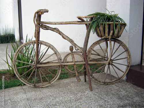 Ecological handmade bike made with pieces of wood logs ornament