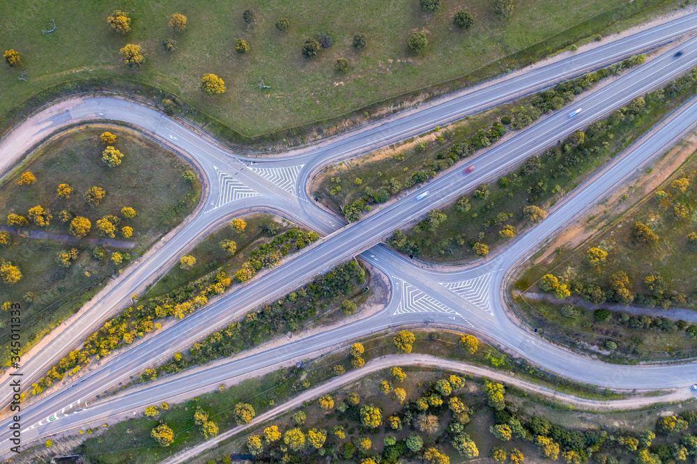 Aerial drone photo of a highway in Spain perfectly alligned with a few cars on the road