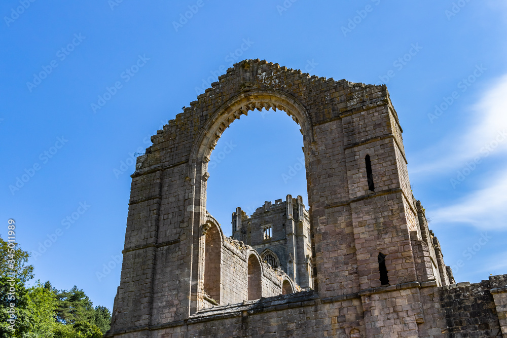 Fountains Abbey and Studley Royal World Heritage Site against a clear blue sky