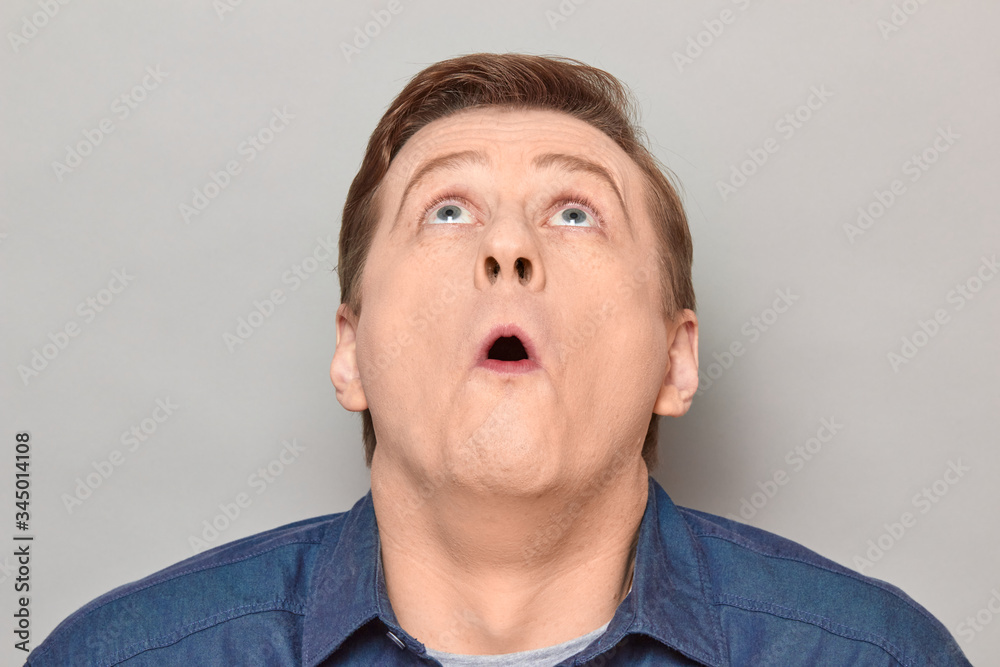 Portrait of shocked mature man with widened eyes and open mouth
