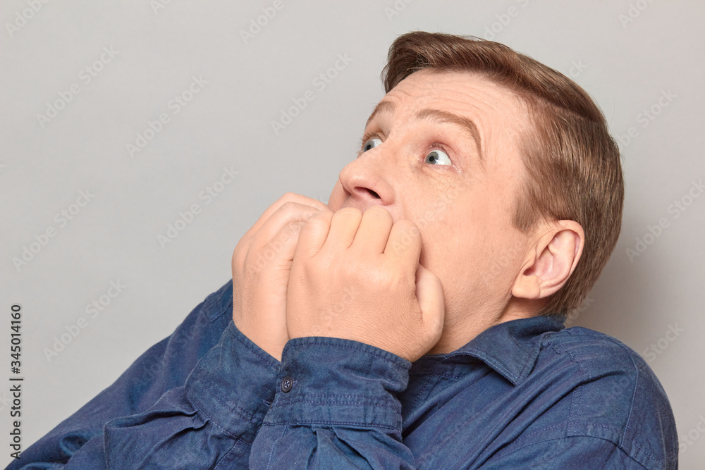 Portrait of shocked frightened man with eyes widened and full of fear Portrait of shocked frightened man with eyes widened and full of fear