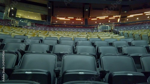 Seats at empty sports concert arena - wide tracking shot
