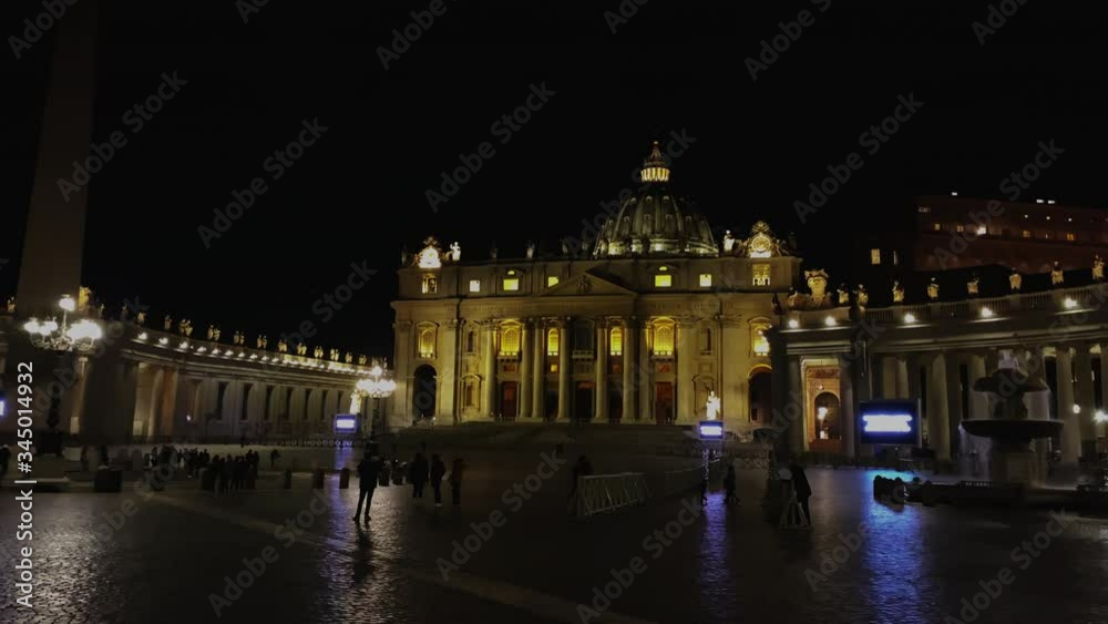 Unrecognizable people walking in the evening in Saint Peter's square in front of the basilica in the Vatican City in Rome Unrecognizable people walking in the evening in Saint Peter's square in front of the basilica in the Vatican City in Rome