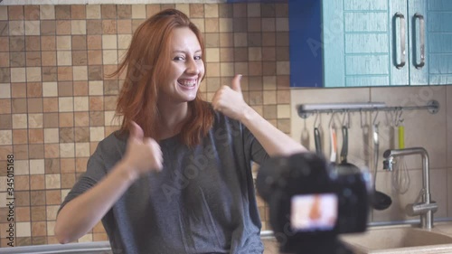 Girl blogger recording vlog for social media. Hipster millennial girl posing in front of camera for blog. Young women vlogger smiling and speaks with followers. Female person making video.