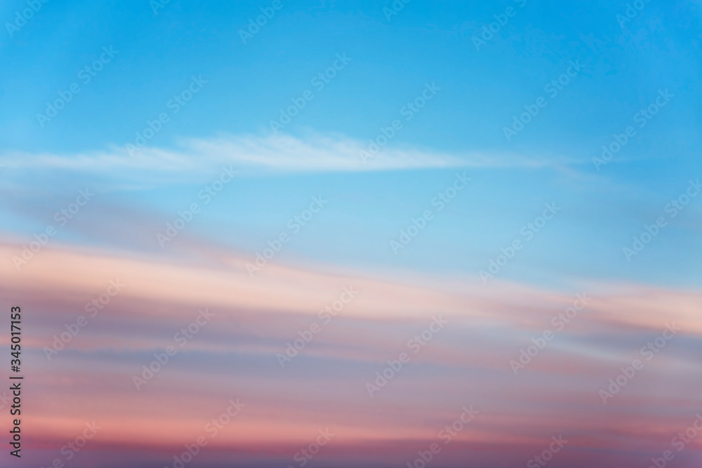 Beautiful pink sunset on a bright blue sky. Space for text. Background.