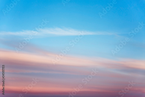 Beautiful pink sunset on a bright blue sky. Space for text. Background. © Анна Демидова