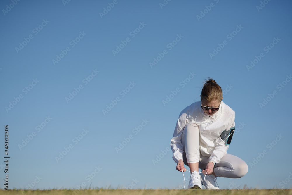 Close up of a fitness woman tying lace of his sports shoes. Close up of a fitness woman tying lace of his sports shoes.