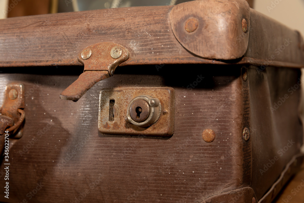 A rusty lock on an old brown leather suitcase A rusty lock on an old brown leather suitcase