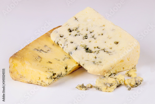 Two pieces of blue cheese with mold.