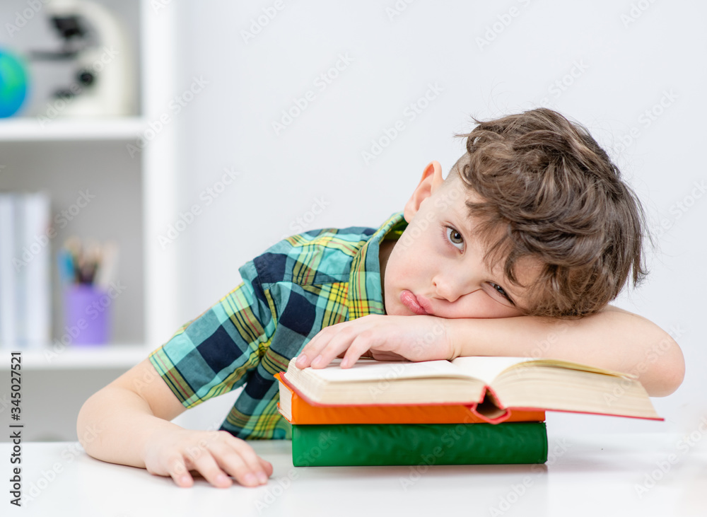 Lazy boy lies on the books at a school Lazy boy lies on the books at a school