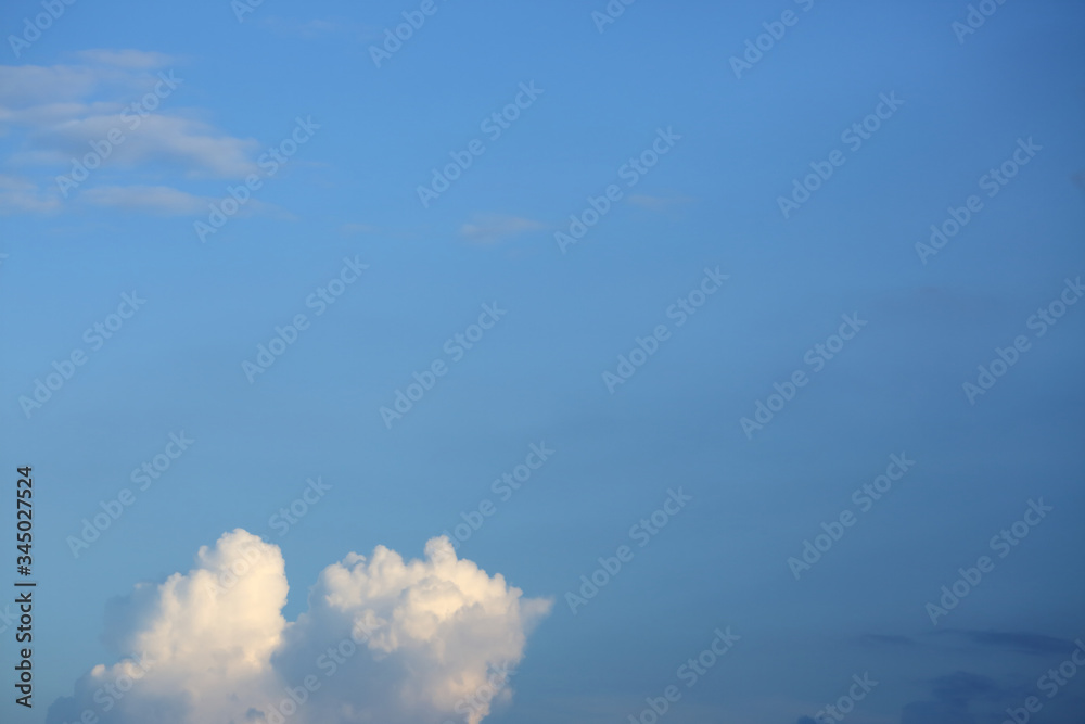 sunlight through fluffy white cloud on clear blue sky background