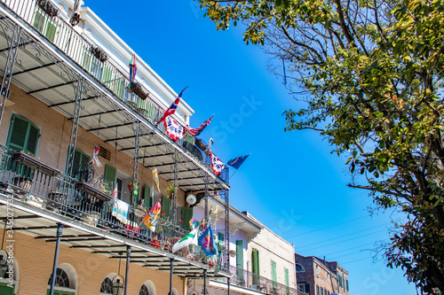 Multicolored Flags Decorate a Balcony Overlooking the French Quarter of New Orleans, Louisiana, USA © E. M. Winterbourne