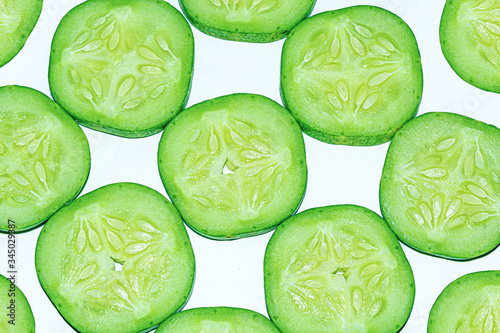 Fresh cucumber slices on white background.