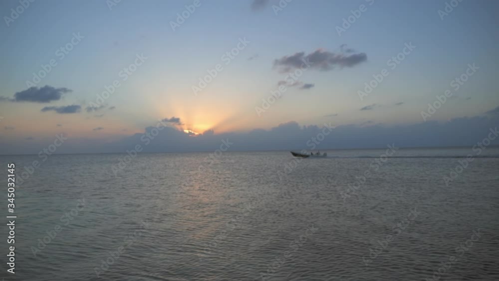 Lockdown shot of boat moving in sea against sky during sunset - Belize City, Belize Lockdown shot of boat moving in sea against sky during sunset - Belize City, Belize