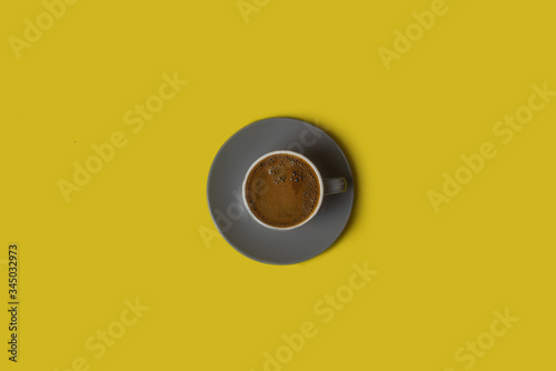 Black coffee isolated on yellow background