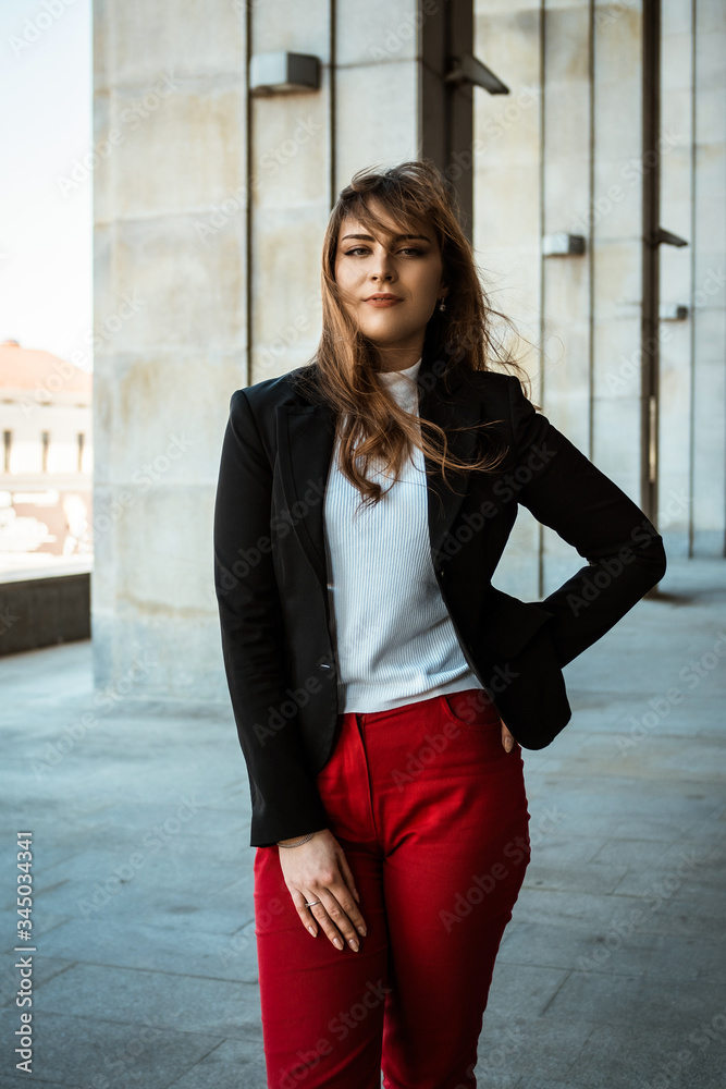 portrait of a young woman in a business suit with long hair.