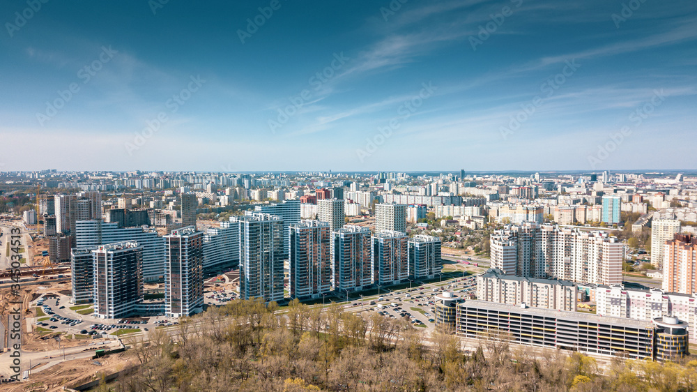 Aerial panoramic view of the construction of residential houses in the microdistricts. Space for text. Cityscape concept.
