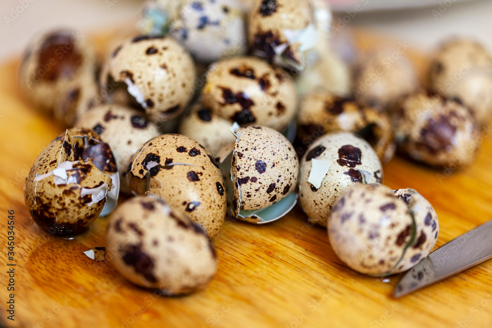  raw quail eggs and shell from on the table.