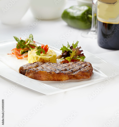 Steak with mashed potatoes and salad.