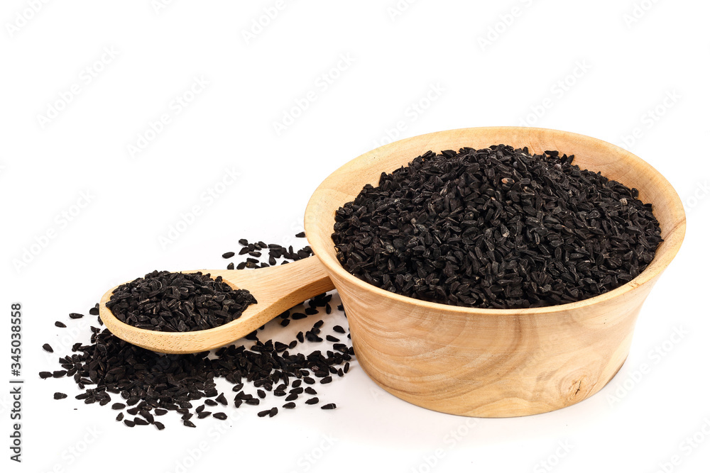 Nigella sativa or Black cumin in wooden bowl isolated on white background Nigella sativa or Black cumin in wooden bowl isolated on white background