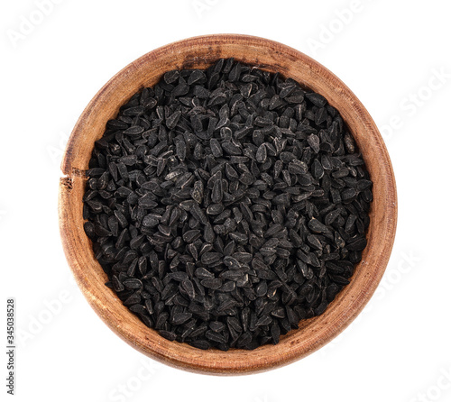 Nigella sativa or Black cumin in wooden bowl isolated on white background. Top view. Flat lay.