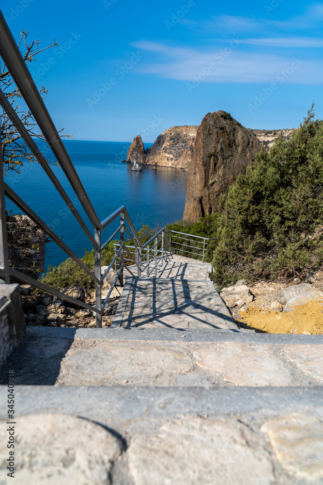 Fototapeta premium A new stone staircase of 800 steps to Jasper Beach, built in the spring of 2020. The reserve on the Black Sea. Cape Fiolent, Crimea Peninsula. The concept of unity with nature, outdoor activities.