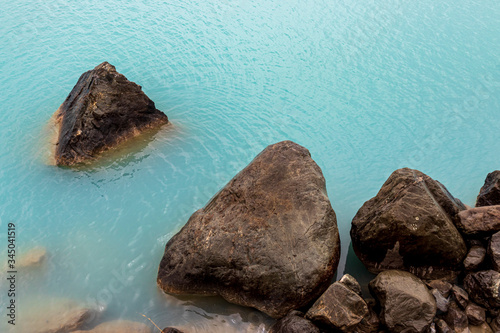 Rocks on the shore at Pukaki lake in New Zealand