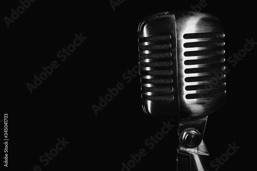 Canvas Print Retro silver microphone on black background