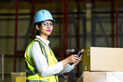 Photography Young latina woman working in the warehouse.